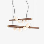Scandinavian walnut pendant light with opal glass globes lit