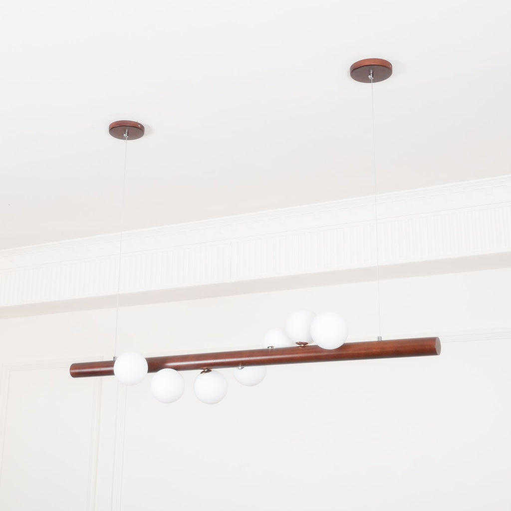 Scandinavian walnut pendant light casting a soft warm glow