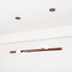 Scandinavian walnut pendant light casting a soft warm glow