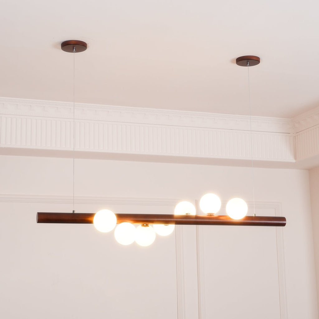 Opal glass globes on a walnut bar lighting a modern room