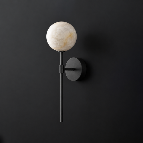 Cutout view of this Clérachic wall sconce in black, its alabaster ball shade glowing against a dark wall.