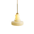 Schoolhouse pendant light with a rounded glass shade glowing