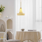 Beige glass schoolhouse pendant in a styled living space