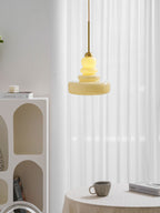 Vintage schoolhouse glass pendant glowing in a warm room