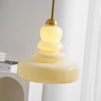 Schoolhouse pendant light glowing warmly above a hallway
