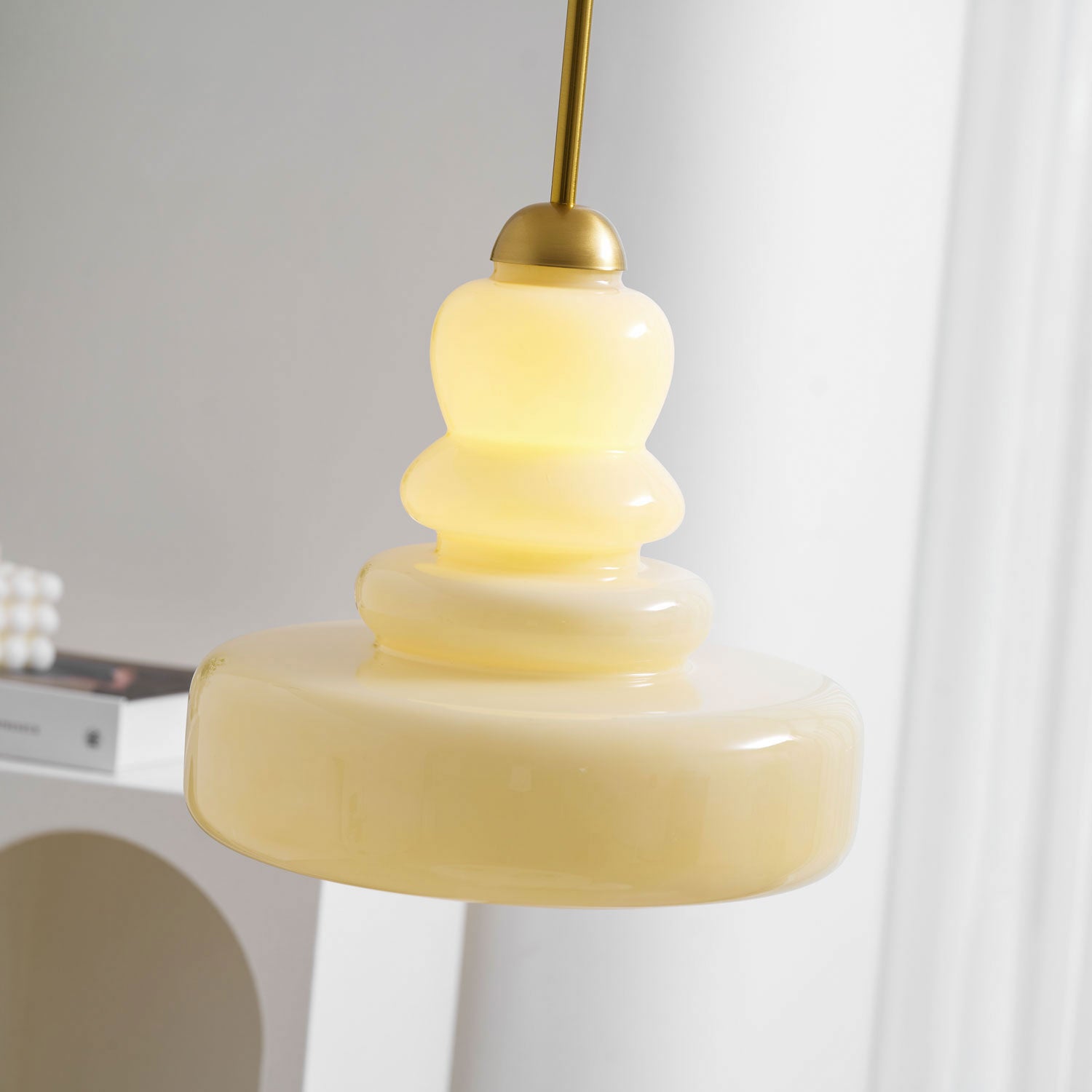 Schoolhouse pendant light glowing warmly above a hallway