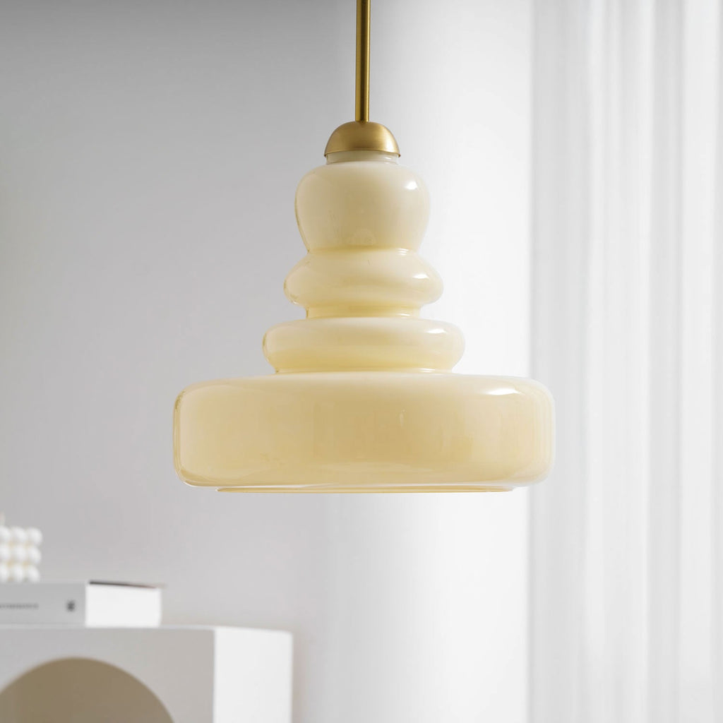 Schoolhouse glass pendant light over a counter at dusk