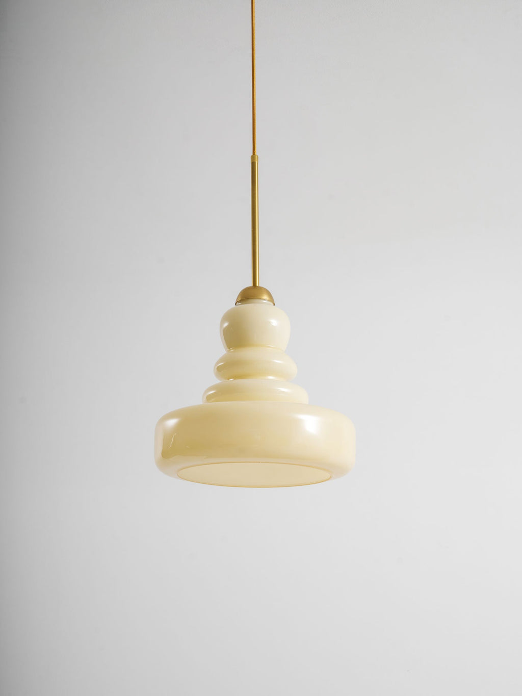 Vintage schoolhouse pendant with glass shade in a warm space