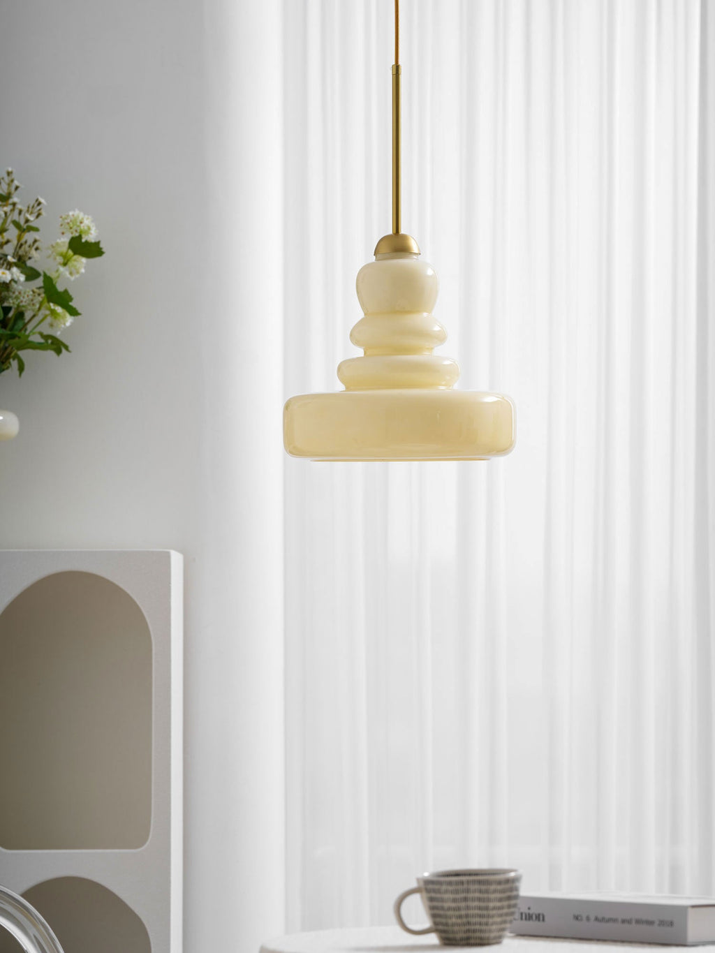 Green schoolhouse pendant light with a glowing glass shade