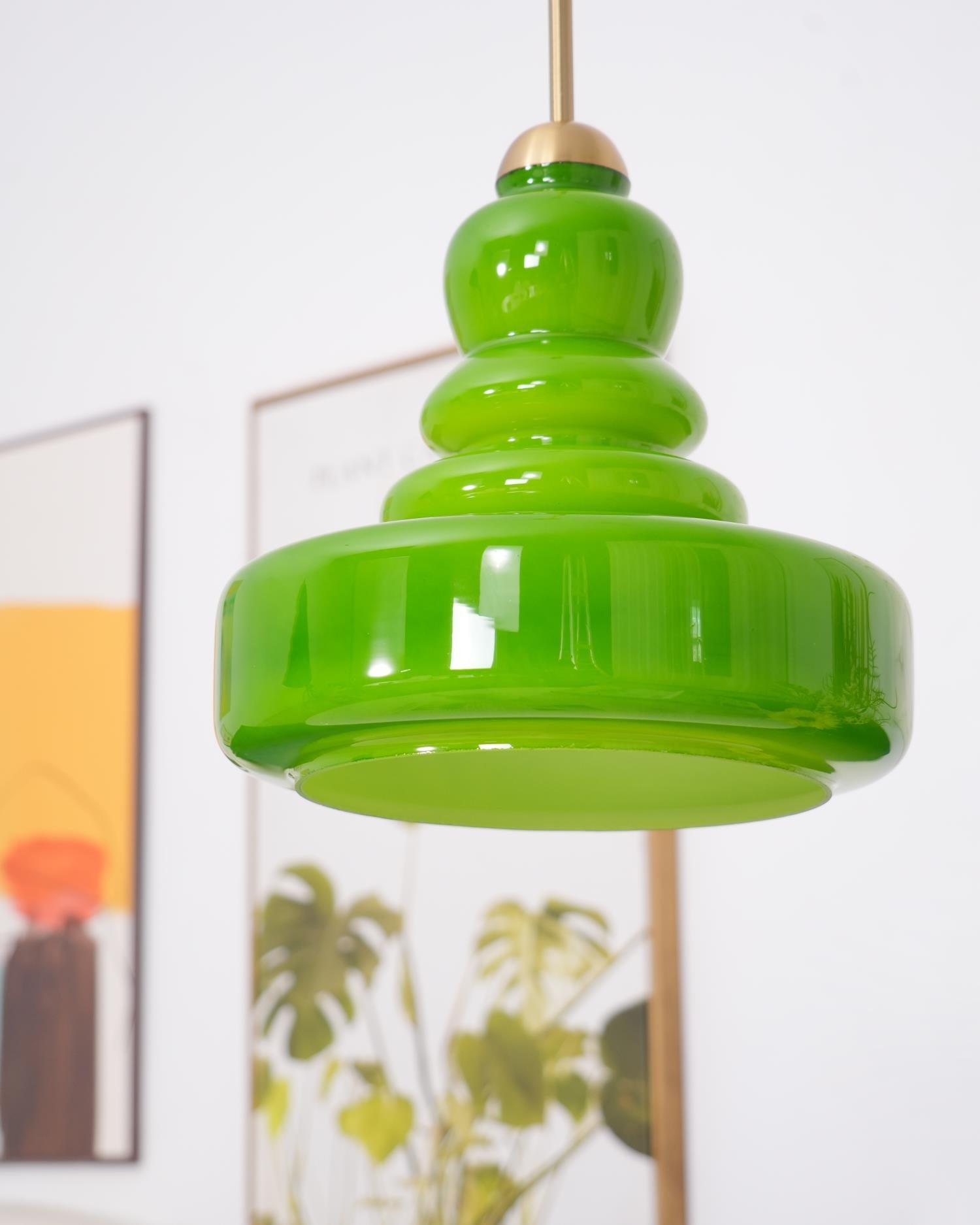 Green schoolhouse glass pendant adding warmth to a room
