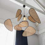 Exposed white beams and dark curtains frame the room where this Clérachic pendant hangs.