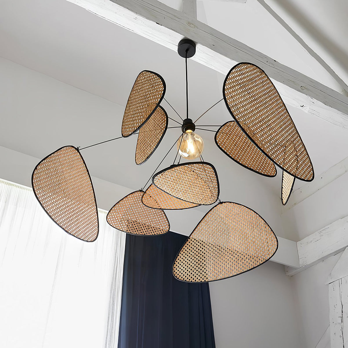 Exposed white beams and dark curtains frame the room where this Clérachic pendant hangs.