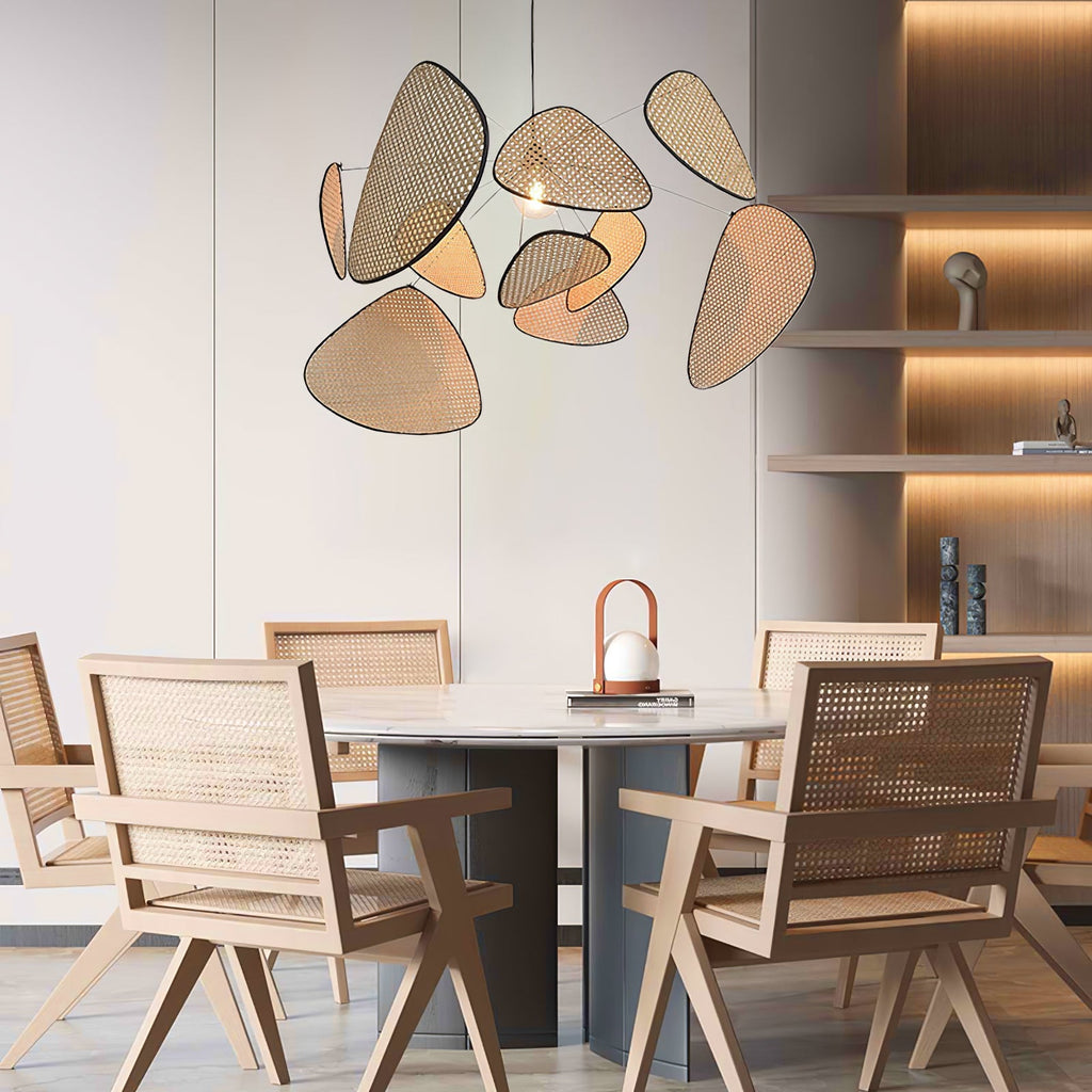 Above a round dining table and pale wood shelving, this Clérachic pendant's bamboo-weave paddles glow warmly.