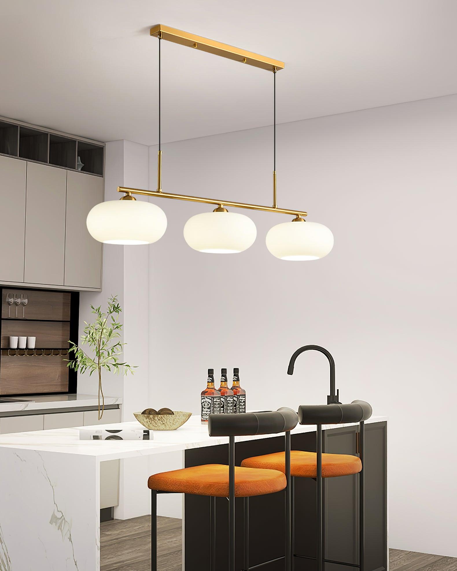Three-globe pendant light suspended in a bright living space