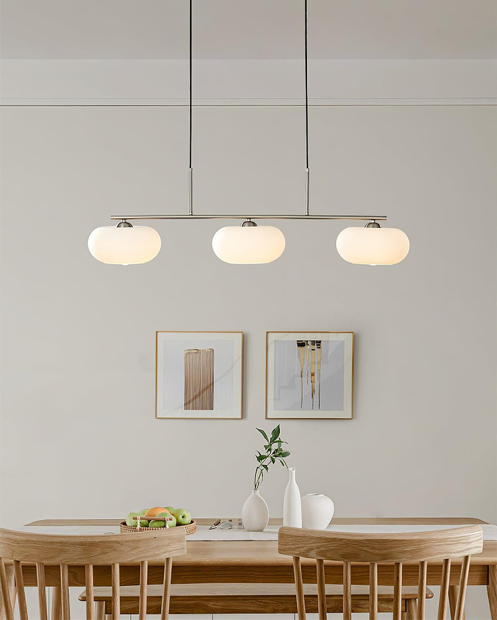 Linear globe pendant light glowing warmly in a modern room