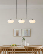 Linear globe pendant light glowing warmly in a modern room