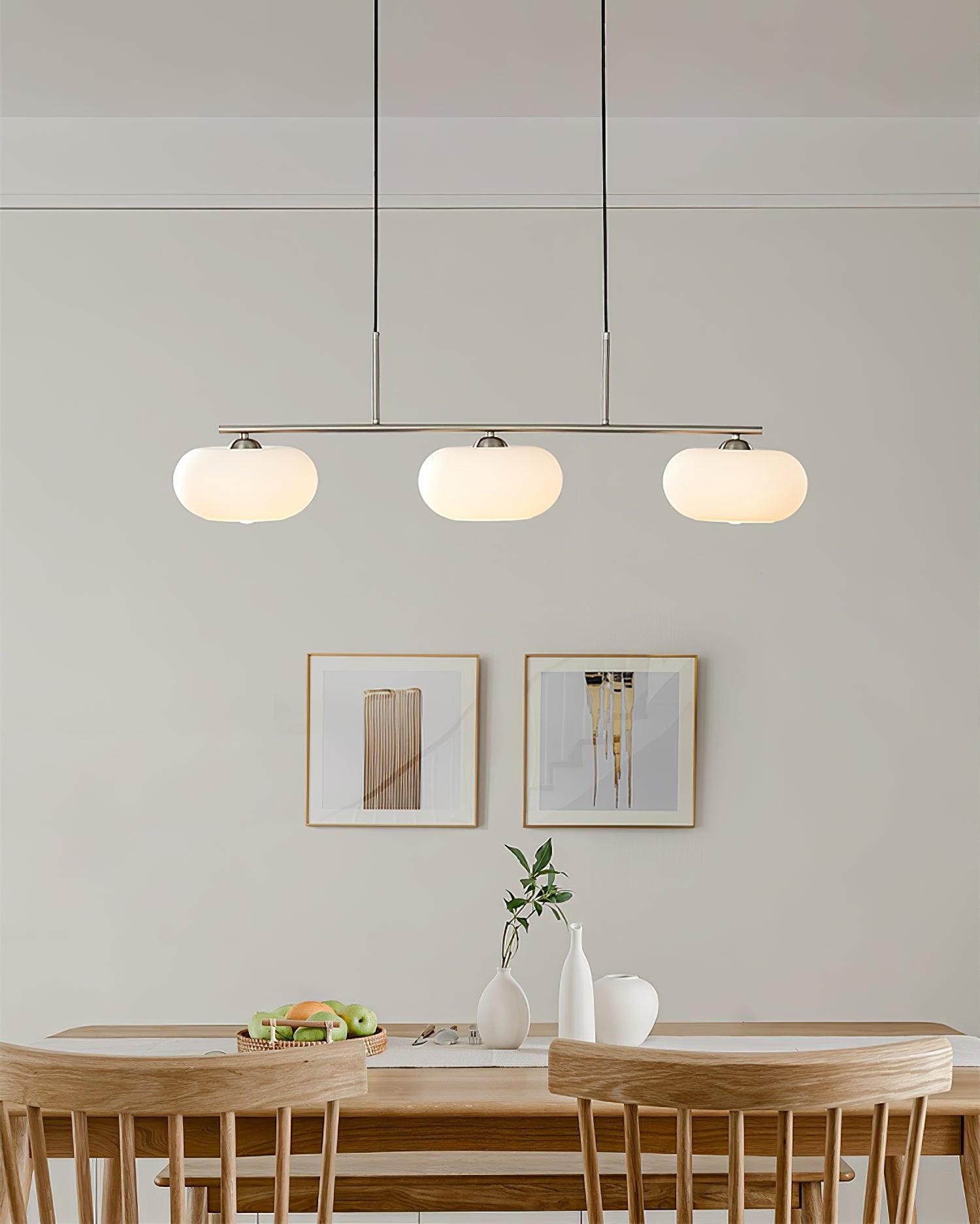 Linear globe pendant light glowing warmly in a modern room