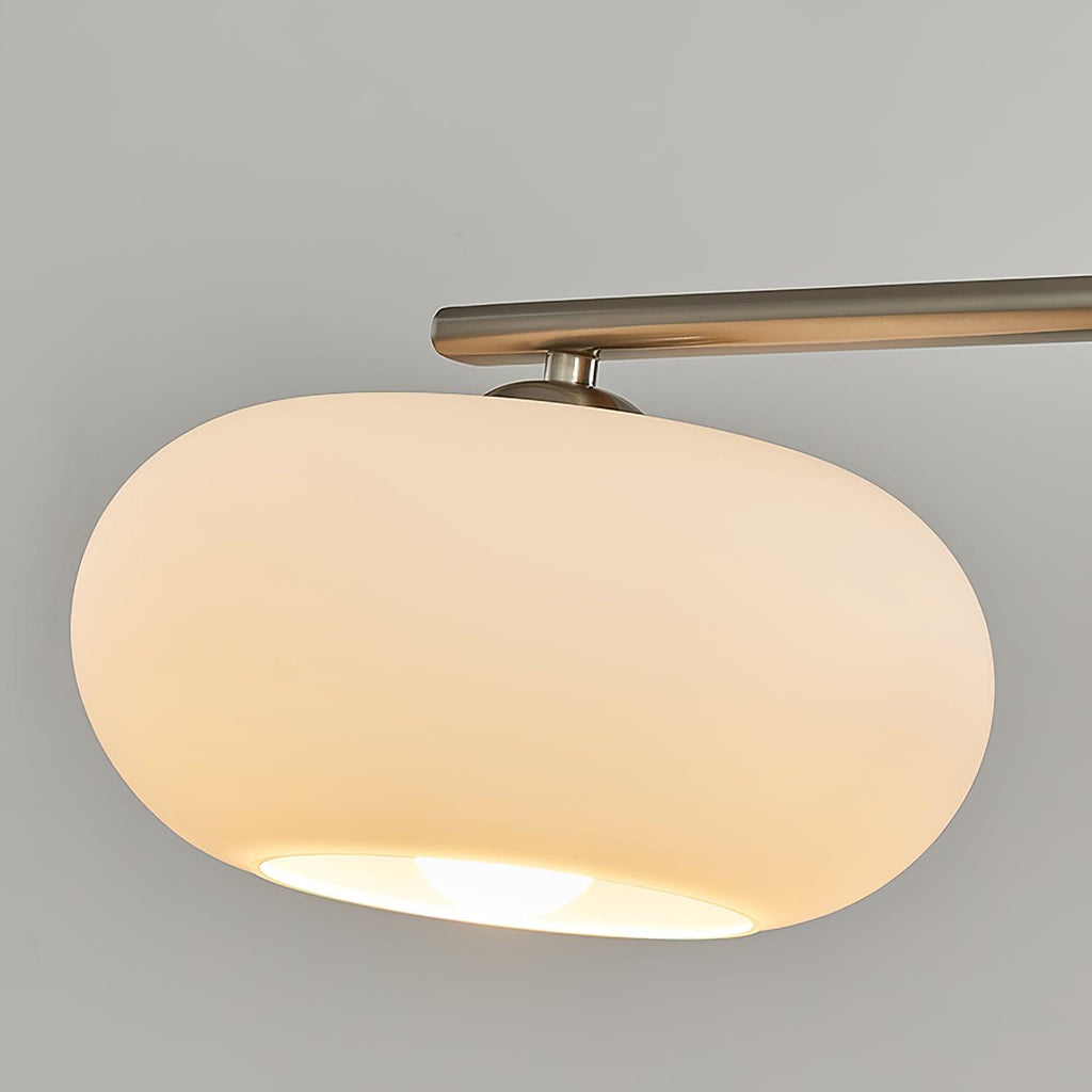 Linear pendant light with three soft glowing glass globes