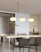 White glass globe shades on a pendant casting a soft glow