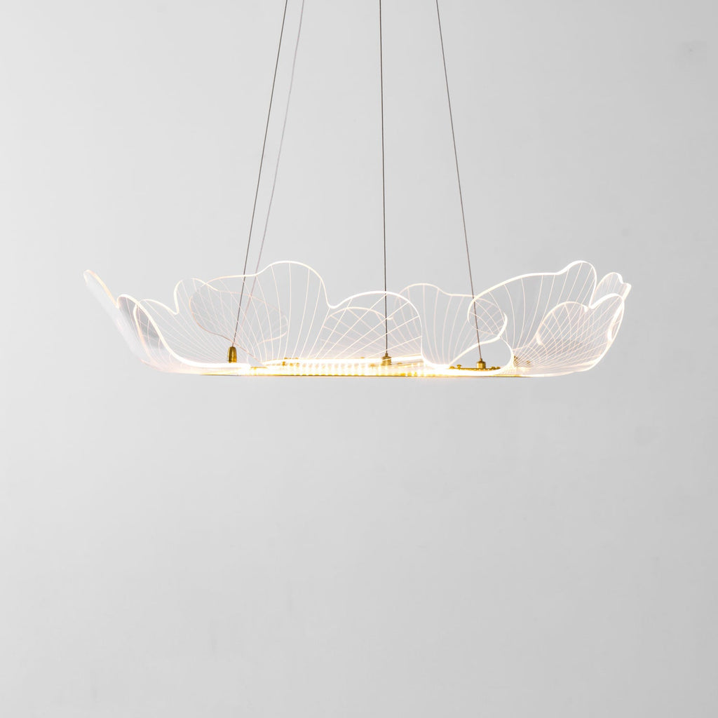 Gold leaf chandelier glowing warmly above an interior space
