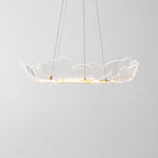 Gold leaf chandelier glowing warmly above an interior space