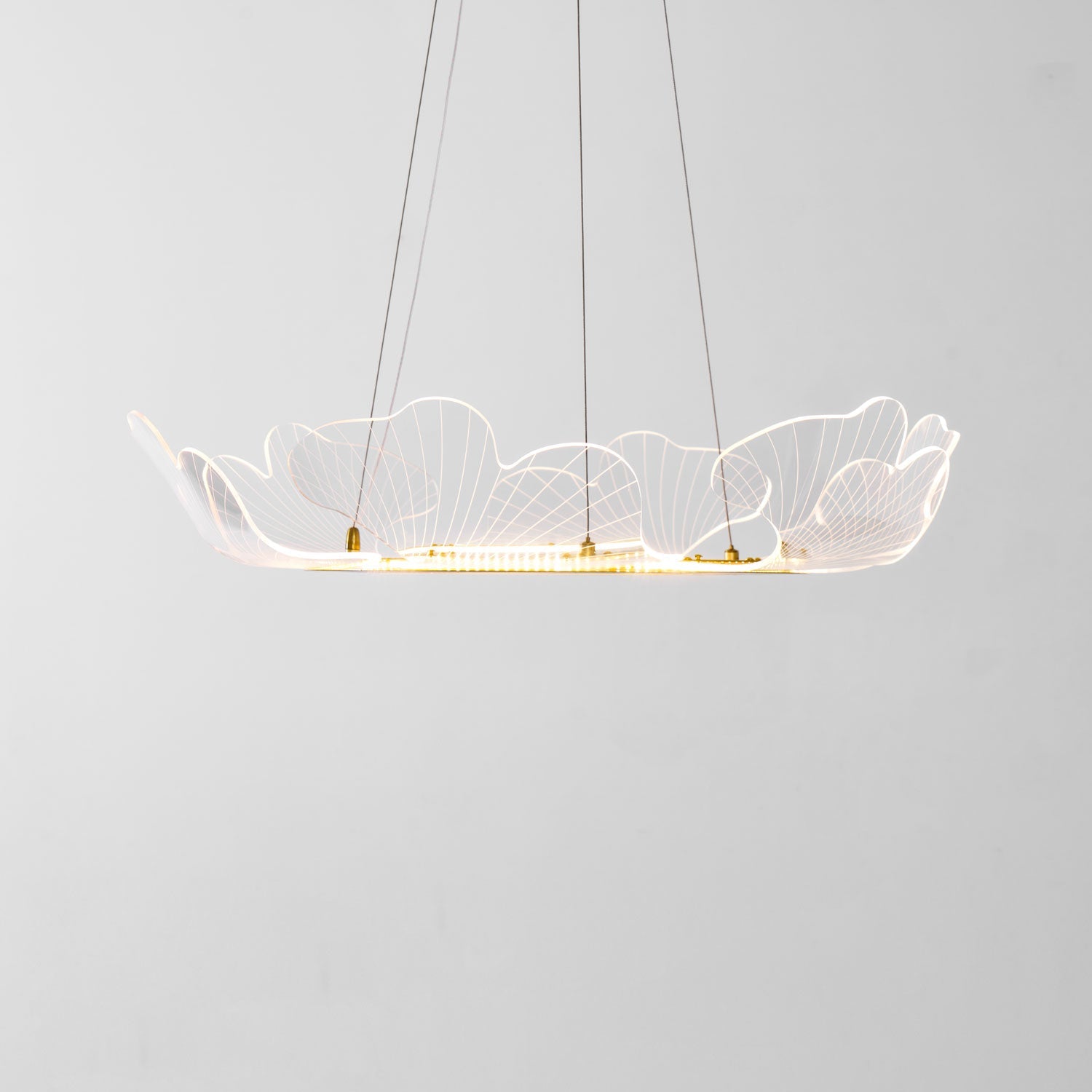 Gold leaf chandelier glowing warmly above an interior space
