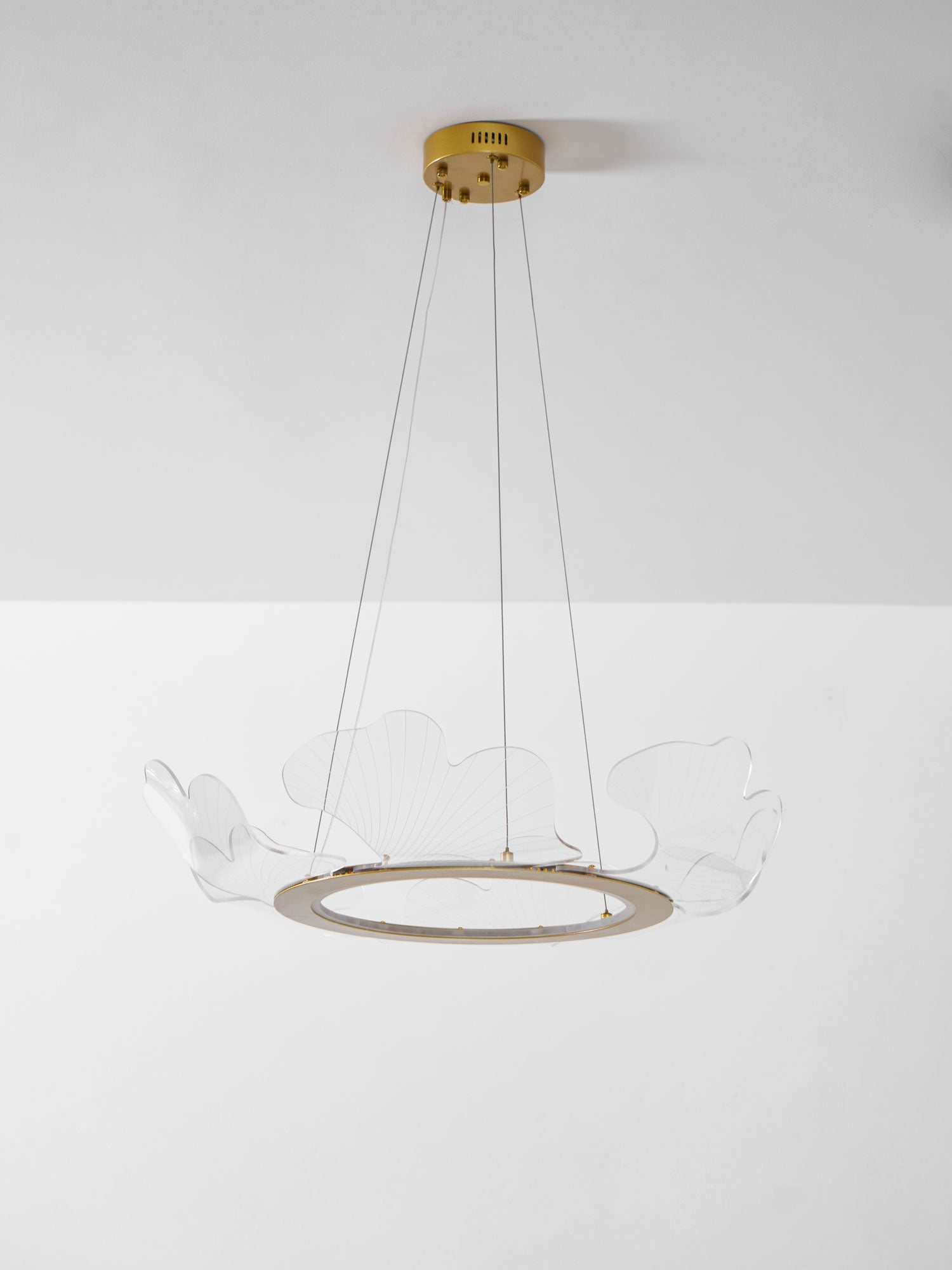 Layered gold leaf chandelier casting a soft even glow