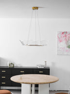 Gold leaf-form chandelier lit warmly in an elegant interior