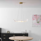 Leaf chandelier in gold finish glowing over a styled table