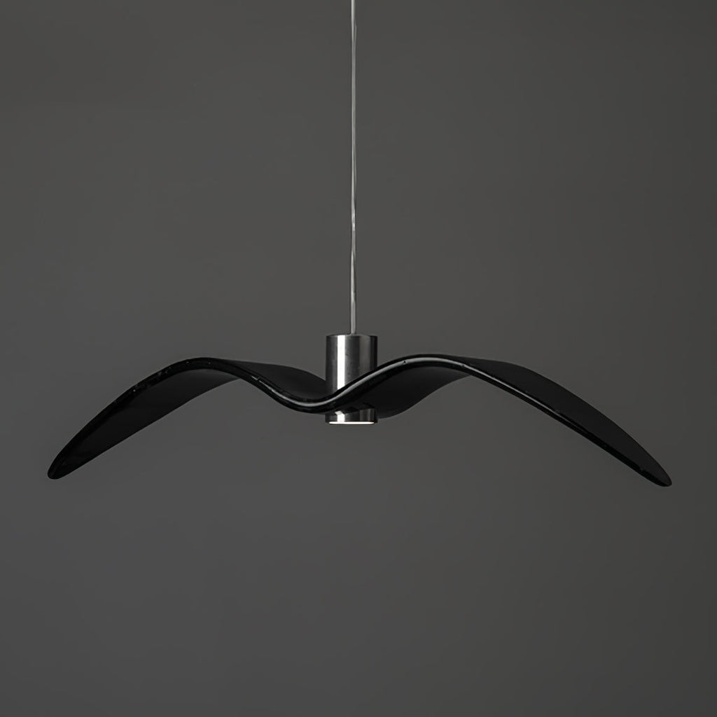 A black bird-shaped pendant from this Clérachic fixture hangs at a slightly different angle, on a plain dark-grey backdrop.