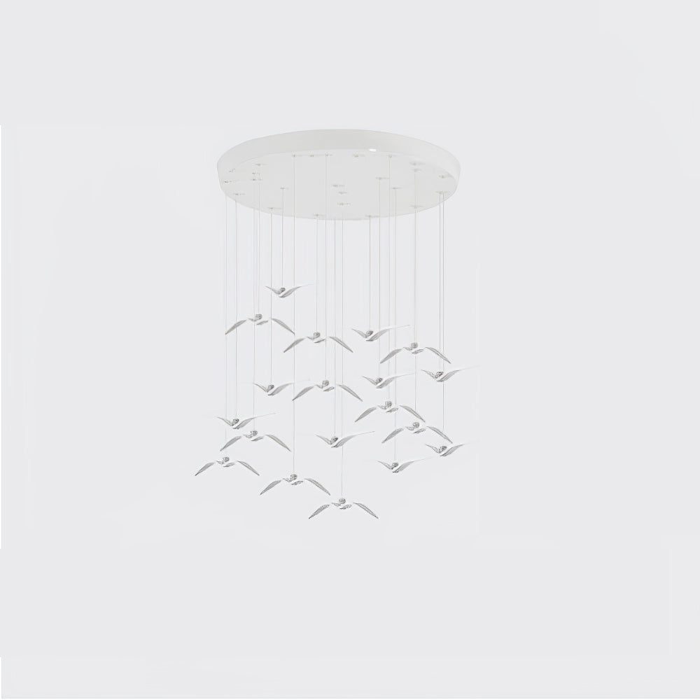 A chandelier of small pale bird-shaped pendants from this Clérachic fixture hangs in tiers from a round white canopy.