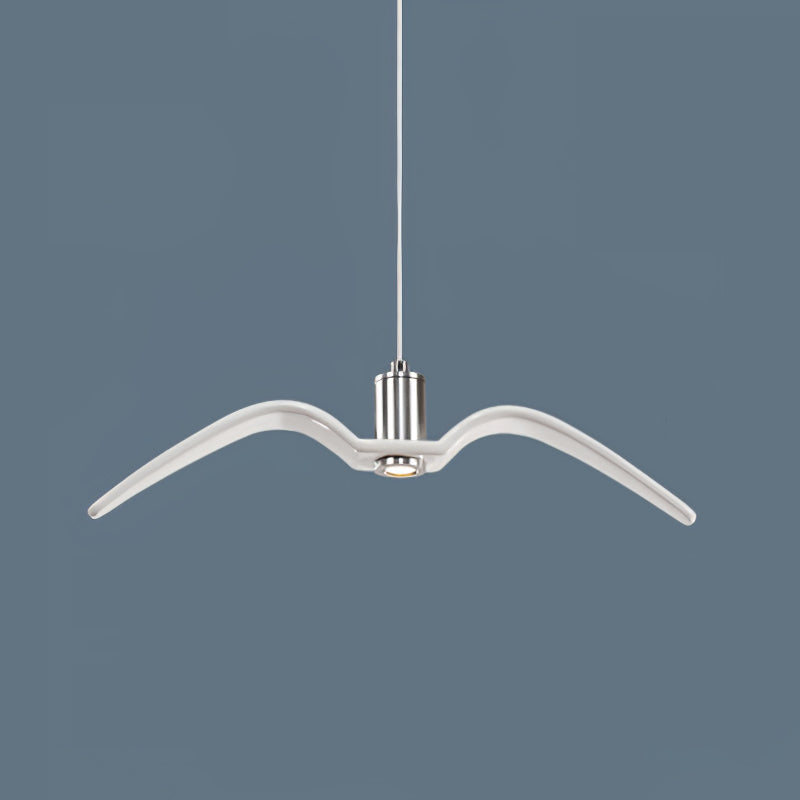 Seen front-on, a single white bird-shaped pendant from this Clérachic light hangs against a slate-blue backdrop.