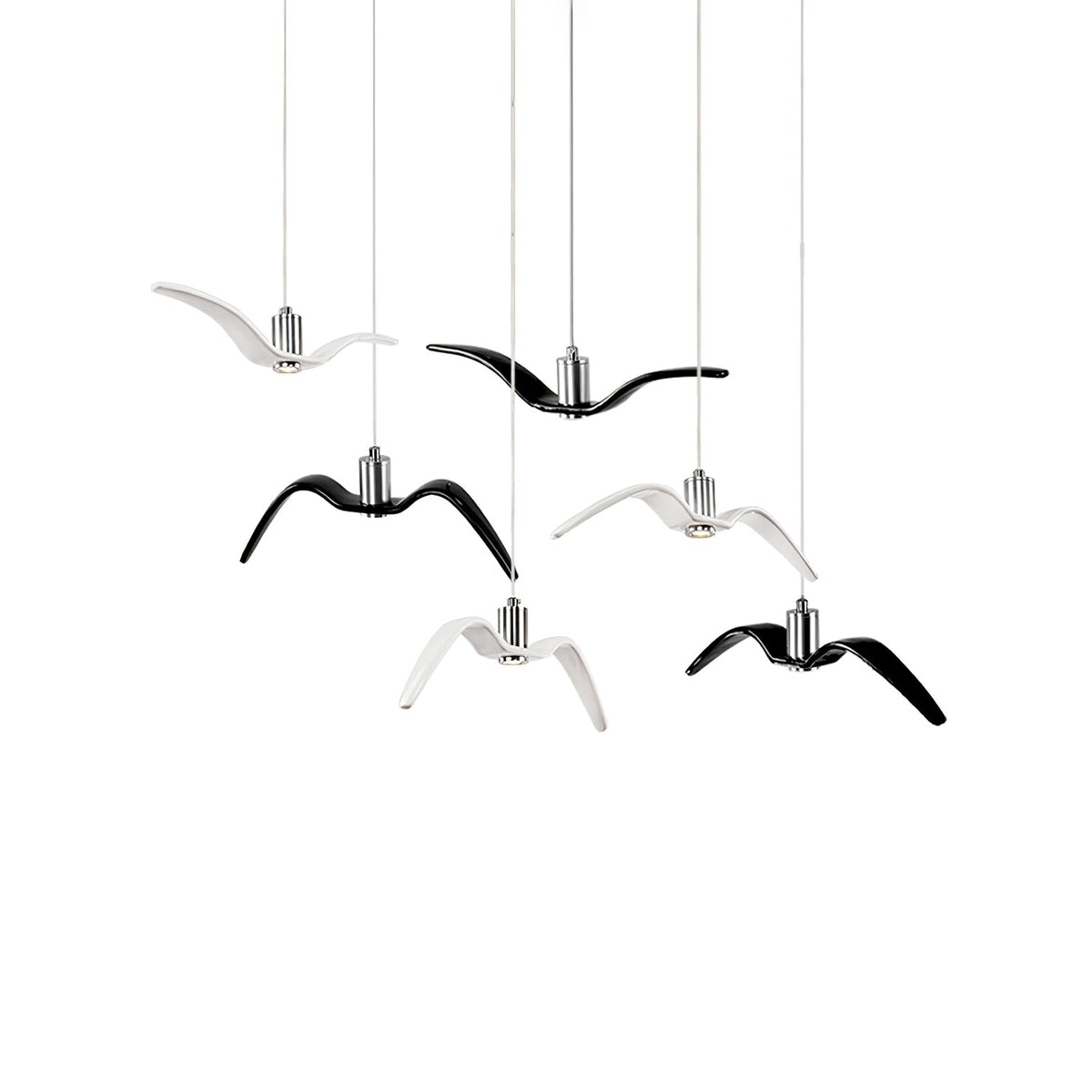 Black and white bird-shaped pendants from this Clérachic fixture hang together at staggered lengths, on a plain white backdrop.