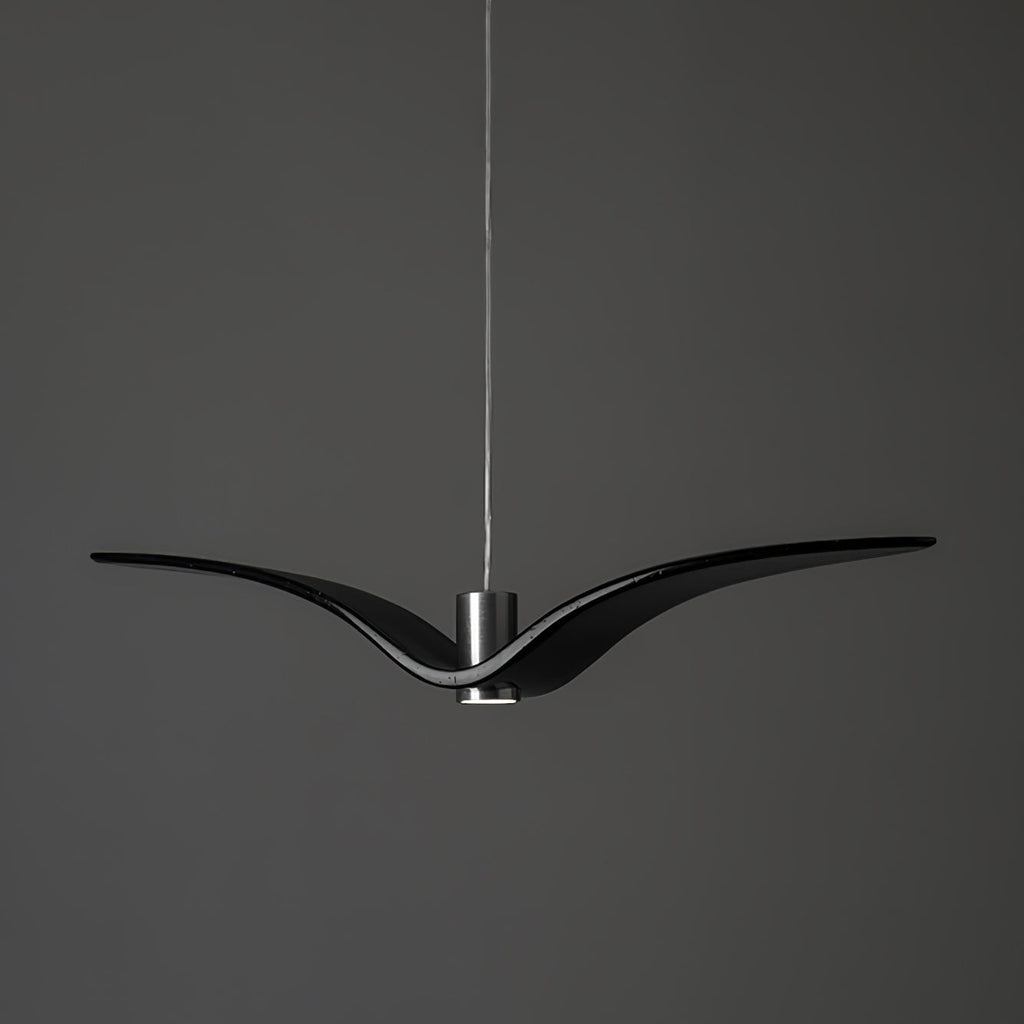 A black bird-shaped pendant from this Clérachic light hangs front-on, on a plain dark-grey backdrop.