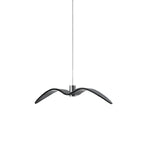 A black bird-shaped pendant from this Clérachic light hangs front-on, on a plain white backdrop.