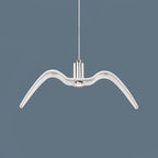 A single white bird-shaped pendant from this Clérachic fixture hangs still against a slate-blue backdrop.