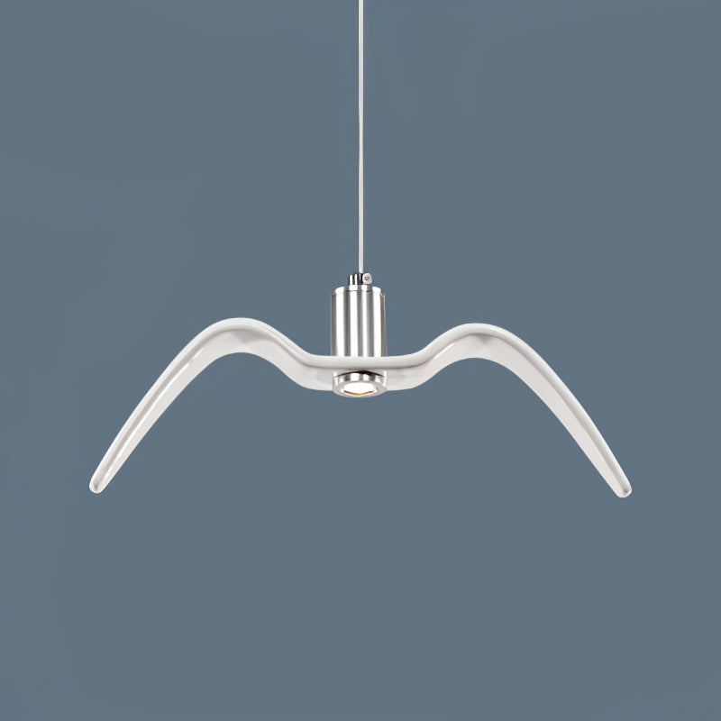 A single white bird-shaped pendant from this Clérachic fixture hangs still against a slate-blue backdrop.