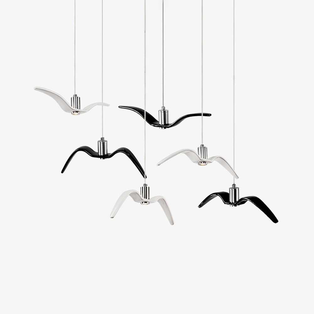 Black and white resin bird pendants from this Clérachic collection cluster together against a plain white backdrop.