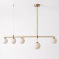 Seen at an angle on a plain white background, this brass Clérachic chandelier hangs unlit, its cable and rod visible.