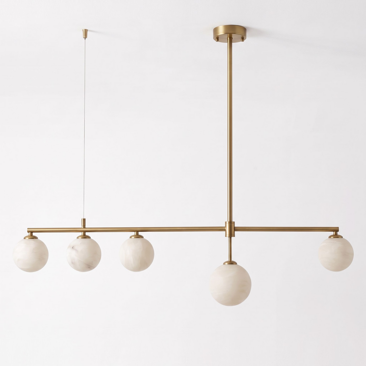 Seen at an angle on a plain white background, this brass Clérachic chandelier hangs unlit, its cable and rod visible.
