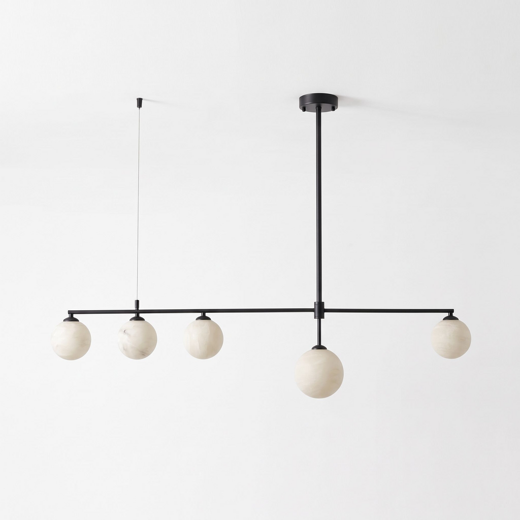 This matte black Clérachic chandelier stands unlit on a plain white background, its five alabaster balls in a row.