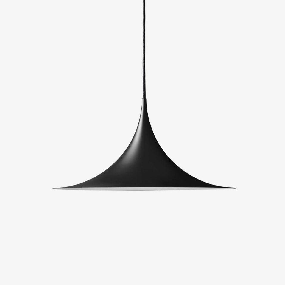 Arch pendant light hanging low over a round dining table