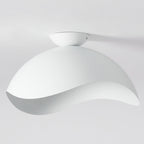 On a plain grey backdrop, this Clérachic wave ceiling light appears unlit, its smooth curve catching the light.