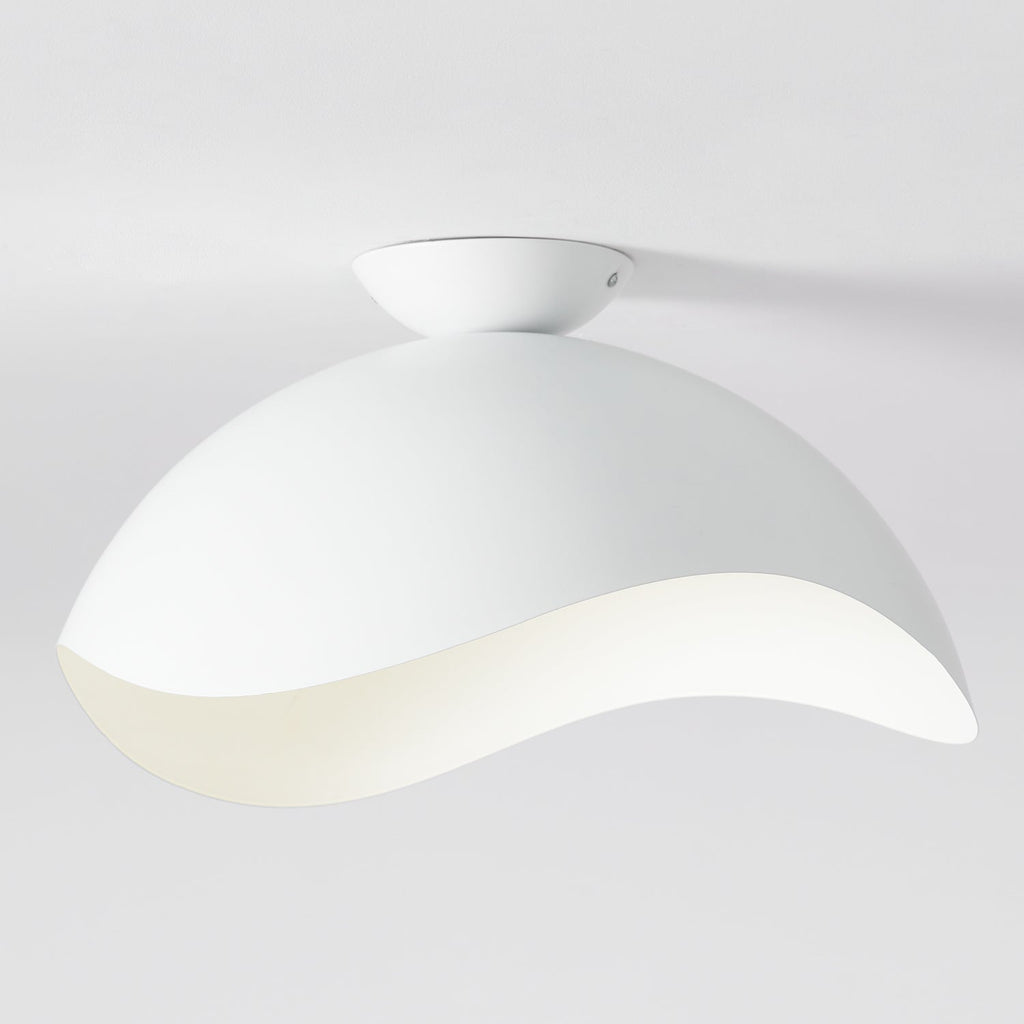 This Clérachic ceiling light in white shows its rounded canopy and curved wave shade against a pale wall.