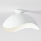 This Clérachic ceiling light in white shows its rounded canopy and curved wave shade against a pale wall.