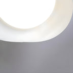 Detail of the smooth curved edge on this Clérachic ceiling light's shade, lit white from within.
