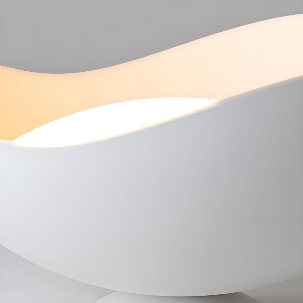 Close-up of the wave-shaped shade on this Clérachic ceiling light, with a warm light band tracing its curve.