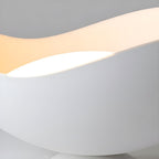 Close-up of the wave-shaped shade on this Clérachic ceiling light, with a warm light band tracing its curve.