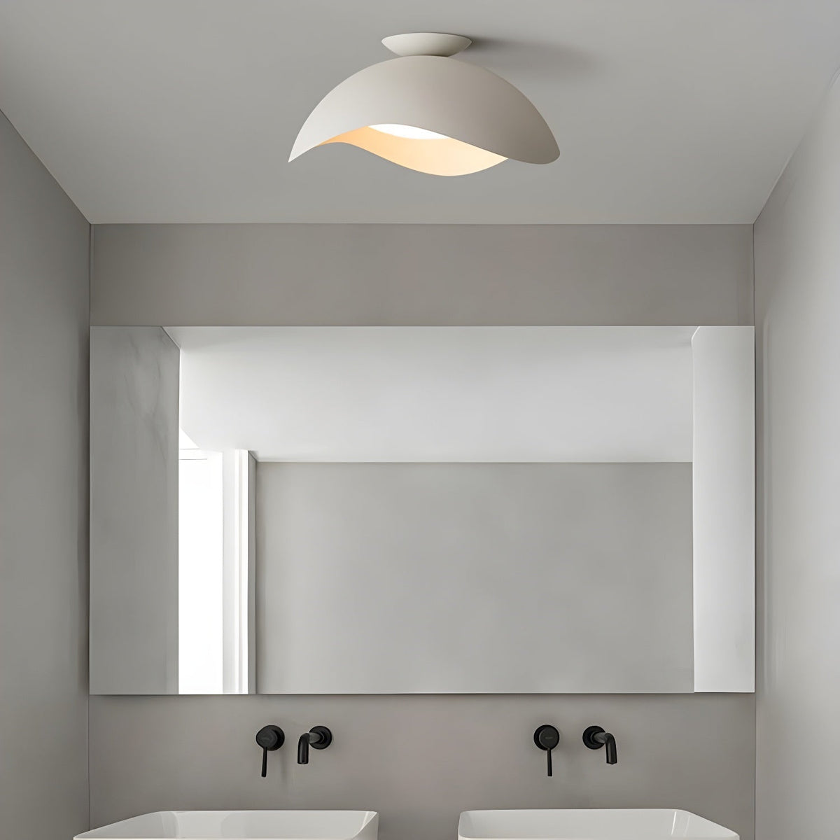 Fitted above a bathroom mirror with black wall taps, this Clérachic ceiling light hangs from a grey ceiling.