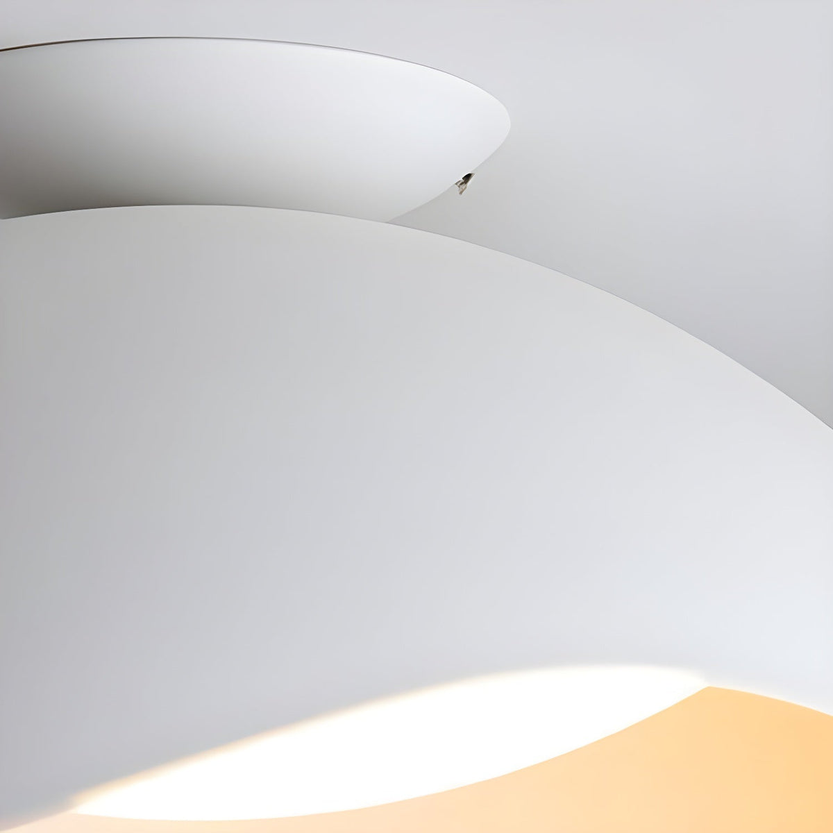 A narrow band of warm light peeks from beneath the curved shade of this Clérachic ceiling light.